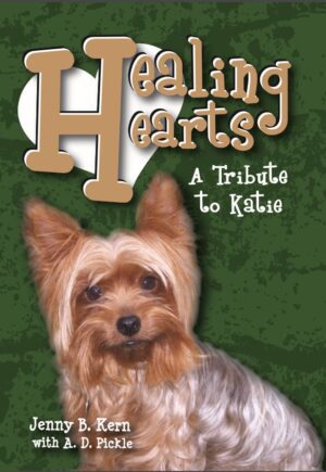 A dog that is sitting down on the cover of a book.