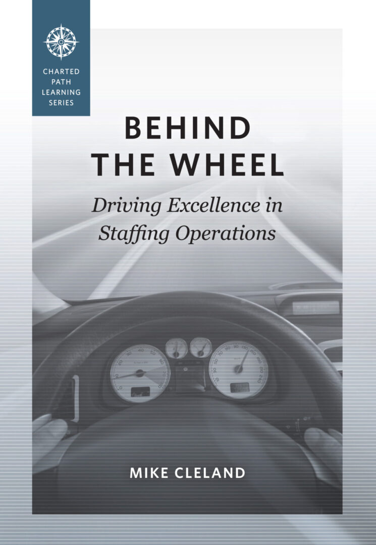 A book cover with the title behind the wheel.