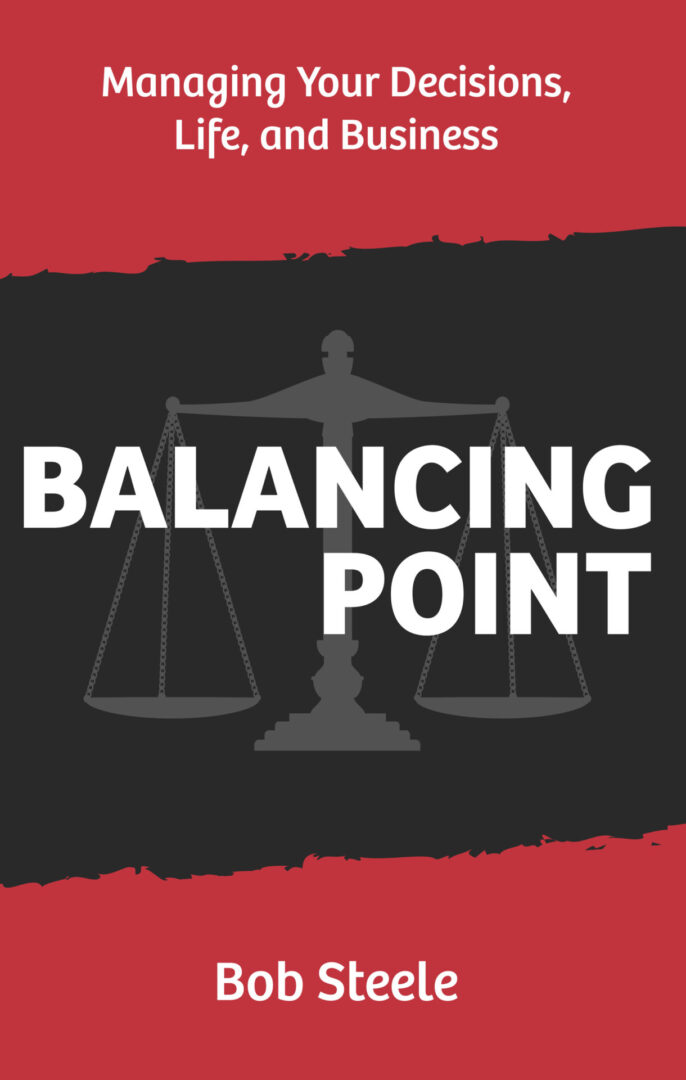 A black and white picture of a balance with the words balancing point underneath.