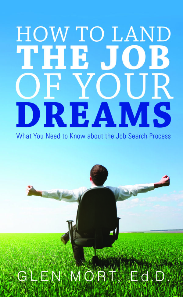 A person in a business suit sits in a chair with outstretched arms against a backdrop of a clear blue sky and green field, featured on the book cover "How to Land the Job of Your Dreams" by Glen Mort, Ed.D.