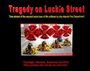 Commemorative tribute featuring firefighter helmets and turnout gear, marking a solemn event with the book 'Tragedy on Luckie Street - Paperback'.