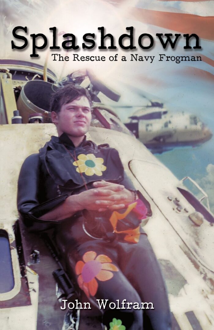 A man in a wet suit with flower stickers, seated in front of a helicopter, on the cover of Splashdown: The Rescue of a Navy Frogman by John Wolfram.