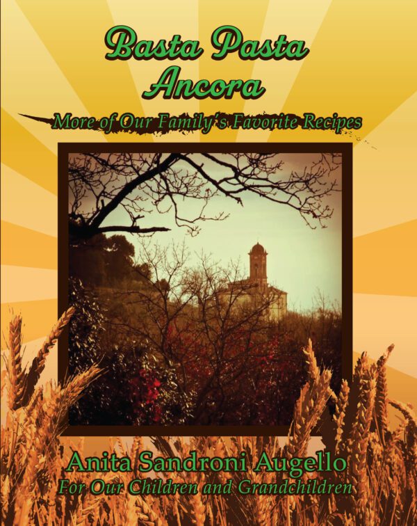 Cover of the Basta Pasta Ancora recipe book by anita sandroni augello, dedicated to the author's children and grandchildren, featuring an image of a landscape with wheat in the foreground and a tower in the background, framed by autumn leaves.