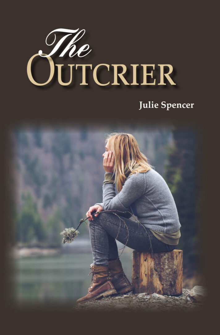 A woman sitting on a stump by a lake, contemplating, with the title "The Outcrier" by Julie Spencer.