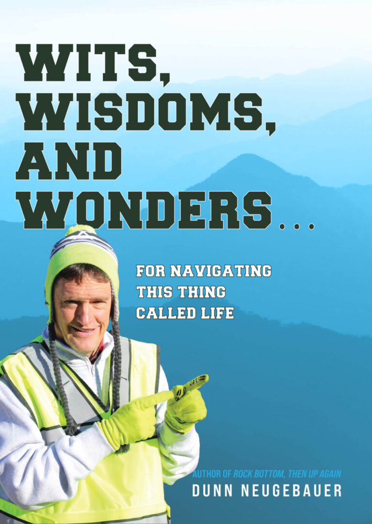 Man in high-visibility jacket holding a pencil with mountain backdrop on a Wits, Wisdoms, and Wonders book cover.