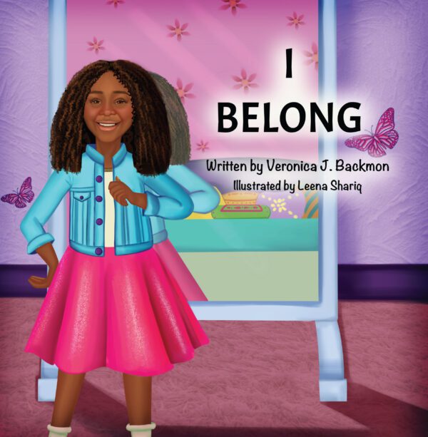 A young animated girl with curly hair standing in front of a book cover titled "I Belong," with butterflies and pink flowers in the background.