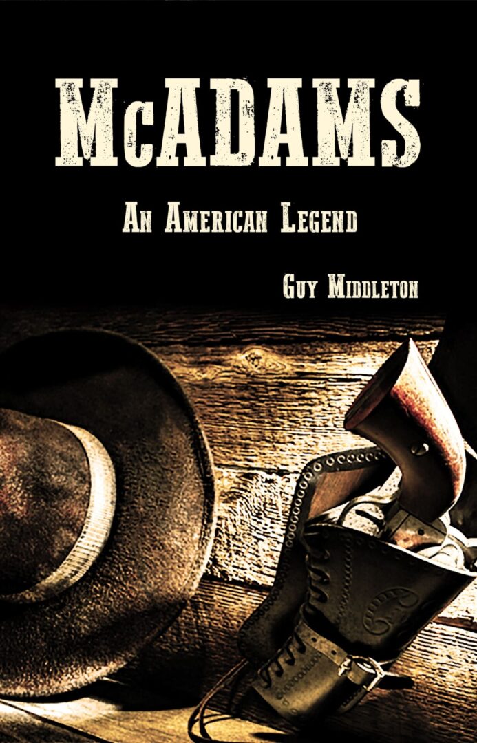 Book cover titled "McAdams: An American Legend" by Guy Middleton, featuring a cowboy hat and holster set against a wooden background.