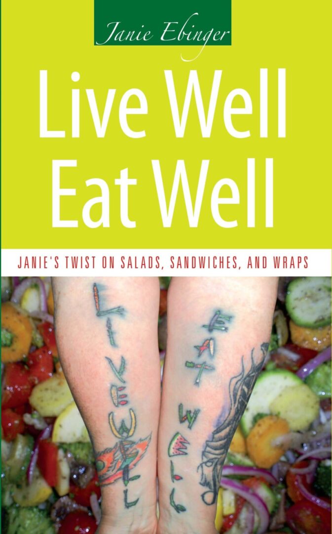 Book cover titled 'Live Well Eat Well' featuring an image of tattooed arms with a background of fresh salads.