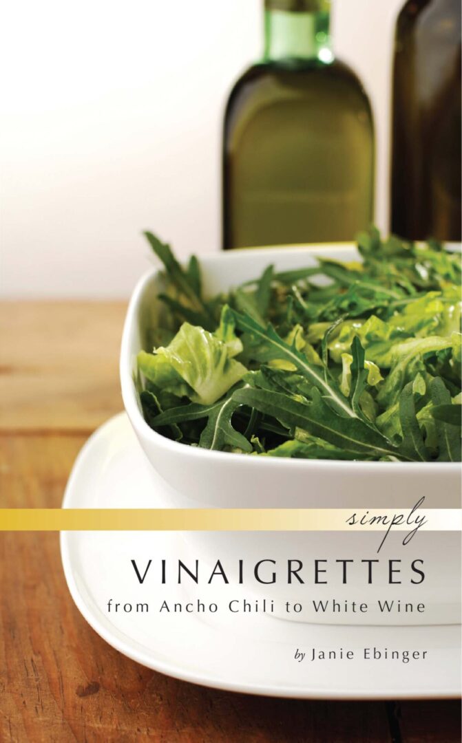 A cookbook titled "Simply Vinaigrettes" by Janie Ebinger, featuring a bowl of leafy greens on the cover.