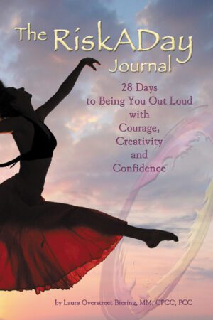 A book cover titled "The RiskADay Journal" featuring a silhouette of a woman dancing against a sunset sky.